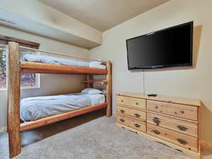 Bedroom featuring visible vents and carpet