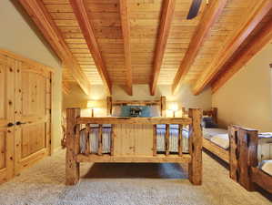 Bedroom featuring beam ceiling, carpet, and wooden ceiling