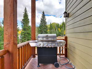 Wooden terrace featuring area for grilling
