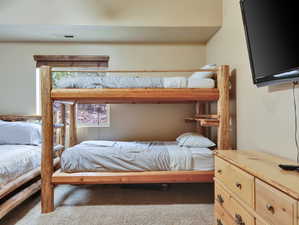Bedroom with visible vents and carpet flooring