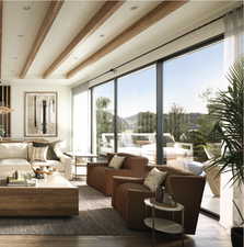 Sunroom / solarium featuring beam ceiling