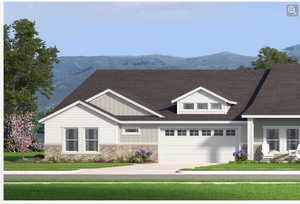 View of front facade featuring a mountain view, stone siding, a garage, and roof with shingles