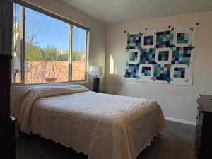 Carpeted bedroom with baseboards