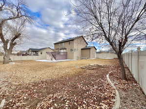 Exterior space featuring stucco siding and a fenced backyard
