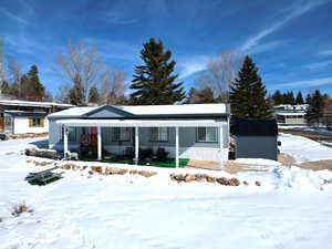 View of front facade featuring an outbuilding and covered porch