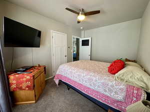Bedroom with ceiling fan and carpet