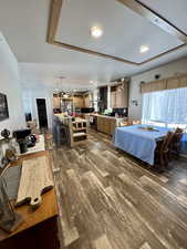Interior space with dark wood-style flooring and freestanding refrigerator