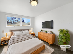 Bedroom featuring dark colored carpet