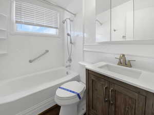 Full bath featuring tasteful backsplash, toilet,  shower combination, and vanity