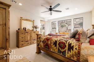 Primary Bedroom with recessed lighting, french doors, light colored carpet, and a ceiling fan