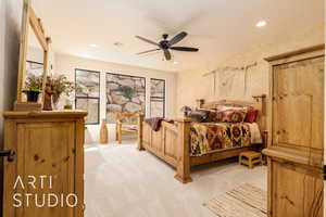 Primary Bedroom with recessed lighting, light colored carpet, and a ceiling fan