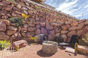 View of xeriscape yard featuring an outdoor gas fire pit