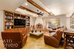 Living room with a ceiling fan, beam ceiling, recessed lighting, and a fireplace.