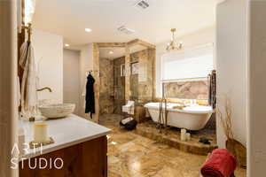 Full Primary bath with double sinks, a freestanding tub, and a walk in shower