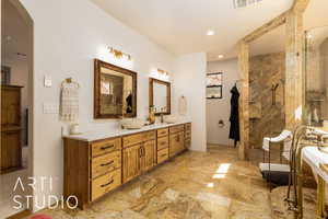 Full Primary bathroom with double vanities, recessed lighting, and walk in shower