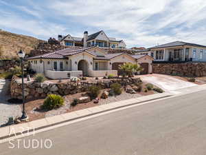 View of front of home with stucco siding, fence, concrete driveway, an attached garage, and a tiled roof