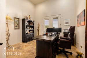 Office/Bedroom #2 area featuring stone finish flooring and French doors