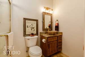 Casita bathroom with stone finish flooring, shower, toilet, and vanity