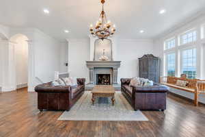 Living room with visible vents, recessed lighting, hardwood / wood-style floors, and a notable chandelier