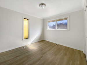 Empty room with visible vents, baseboards, and light wood-style flooring