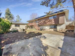 Back of house with brick siding, stairway, a patio area, and a deck