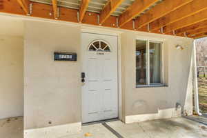 View of exterior entry featuring stucco siding