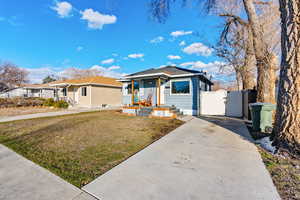 View of front facade with a front lawn and a gate