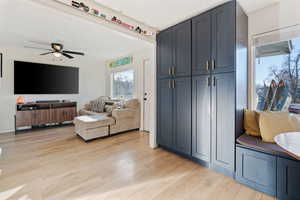 Living room featuring light wood-style floors and ceiling fan