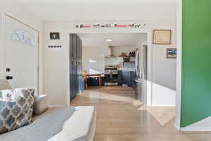 Entrance foyer with baseboards and light wood-type flooring