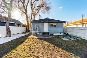 Back of property with entry steps, a patio, a yard, and a fenced backyard