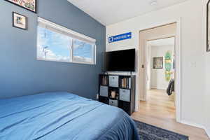 Bedroom with baseboards and wood finished floors