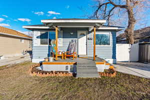 Bungalow featuring a gate and fence