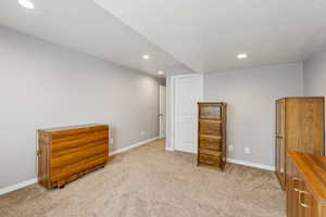 Interior space with recessed lighting, baseboards, and light carpet