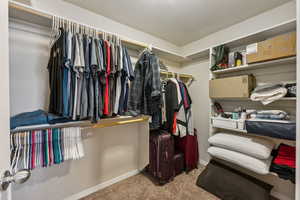 Spacious closet with carpet floors