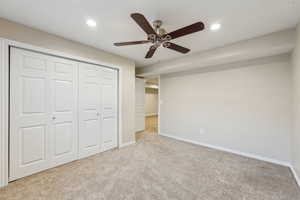 Unfurnished bedroom featuring a closet, recessed lighting, baseboards, and carpet floors