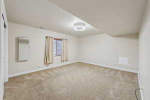 Spare room featuring baseboards, visible vents, and carpet floors