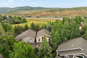 Aerial view of property and surrounding area with a mountain backdrop