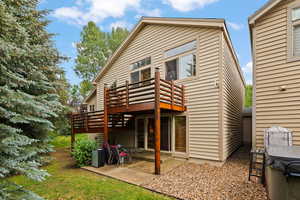 Back of property with a deck and a patio area