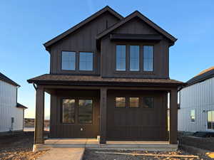 View of front facade featuring board and batten siding and a porch