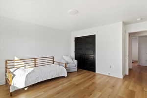 Bedroom with baseboards and wood finished floors