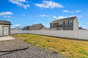 View of yard with a residential view, a fenced backyard, and a patio area