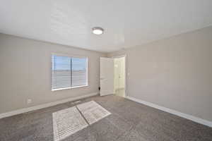 Spare room with visible vents, light colored carpet, and baseboards