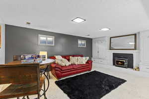 Living area featuring a brick fireplace and a textured ceiling