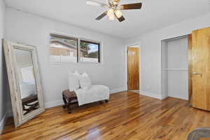 Master bedroom featuring light wood-style flooring, a textured ceiling, and a ceiling fan