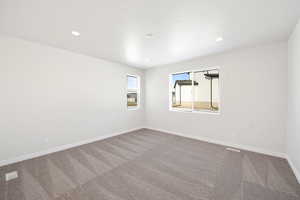 Unfurnished room featuring carpet flooring, recessed lighting, and baseboards