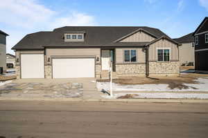 View of front of house with board and batten siding, concrete driveway, a garage, and roof with shingles