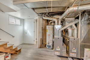 Below grade area featuring stairs and water heater