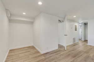 Interior space with baseboards, recessed lighting, visible vents, and light wood-type flooring