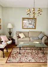 Living area featuring wood finished floors and a chandelier