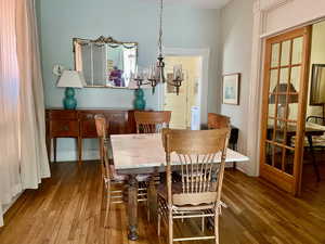 Dining space with a chandelier and hardwood / wood-style floors